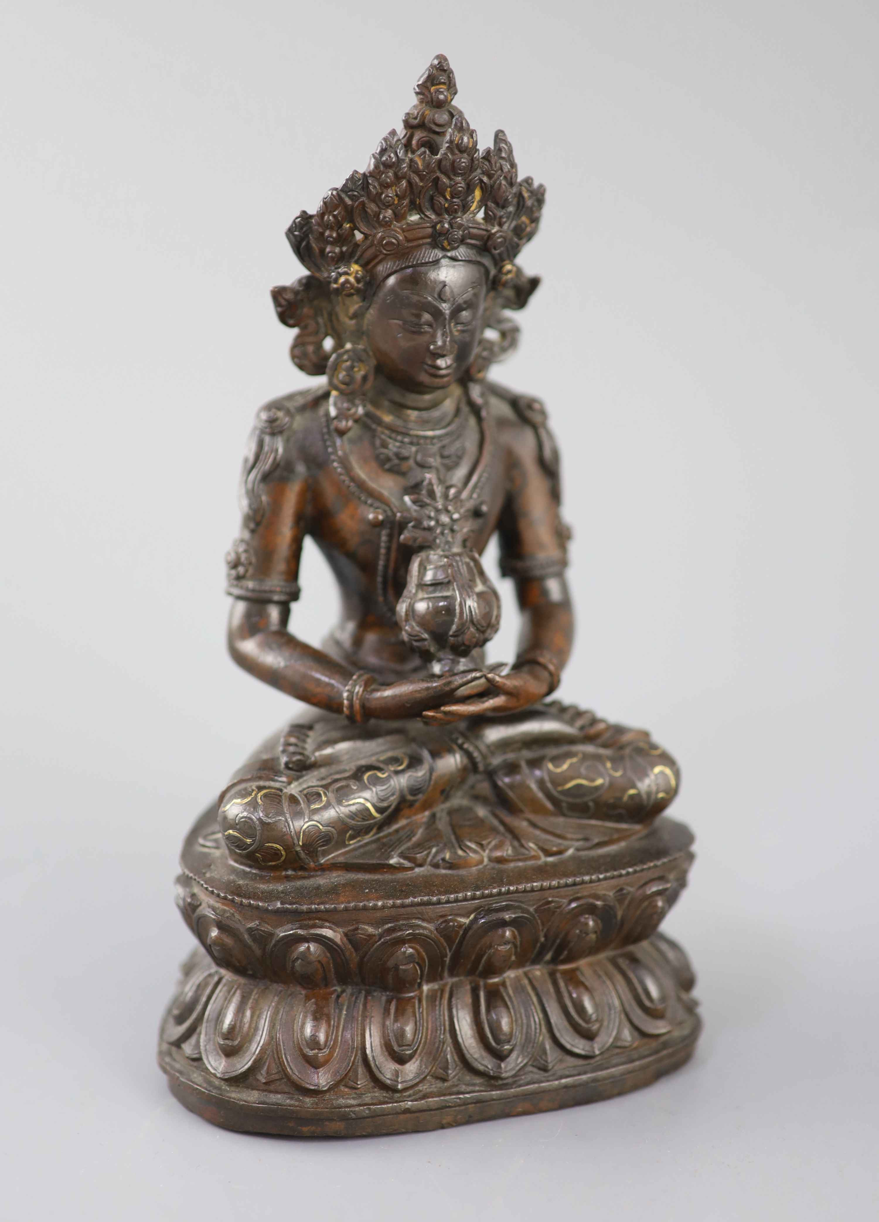 A Tibetan silver and gold inlaid copper alloy figure of Amitayus/Amitabha, c.15th century, 20.5cm high